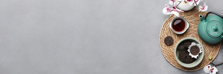 Aromatic pu-erh tea served on grey table, top view. Banner design with space for text