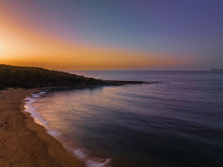 Hazy sunrise over the beach and mountain