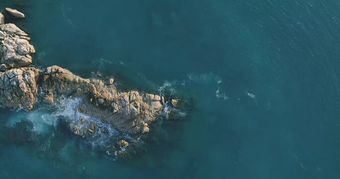 Aerial view waves break on  island beach at sunset. Sea waves on the beautiful island aerial view drone 4k Anse Lazio Beach, Praslin Island, Seychelles. people on the beach