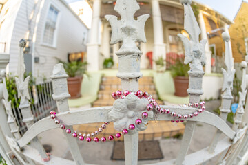 Mardi Gras beads hung over a fence in the French Quarter in New Orleans, Louisiana. Focus is on the...