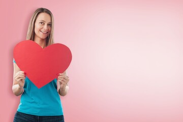 Young happy woman holding big red heart