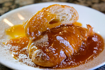 the hands of the chef in gloves cut a delicious dessert soft airy porous croissant Croissant Caramel Almond Slice Sweet Delicious. High quality photo