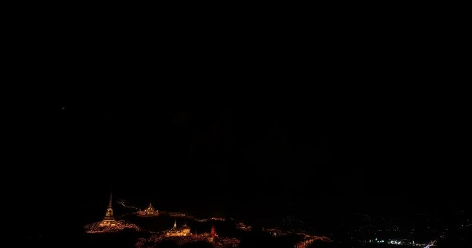 aerial view Beautiful fireworks light up the palace atop a hill in the heart of the city..Colorful lights decorate the palace and pagoda at the top of the mountain at night.