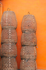 wicker basket pile on a orange wall background