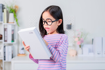 education and school concept - little student girl reading book