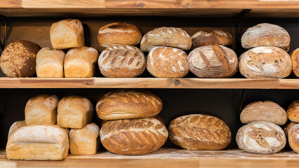Loaf of fresh baked bread on a shelf. Loaves of bread market showcase