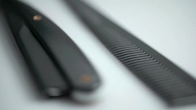 Closeup Of Hairdressing Scissors, Comb And Razor. Rotating Turntable Shot