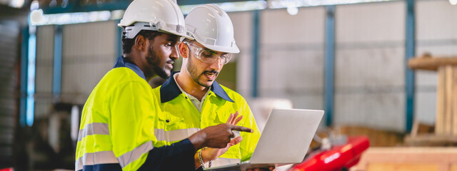 professional technician engineer with safety helmet hard hat working in industrial manufacturing...