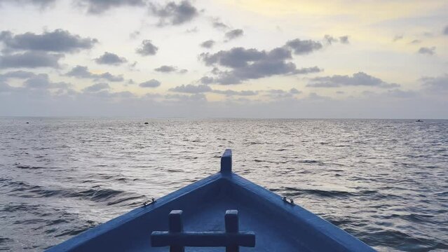 Scenic Drive on a Traditional Dhoni Boat Across the Turquoise Waters of Maldives, as the Glorious Sun Descends into the Horizon, Painting the Sky with Hues of Gold and Orange
