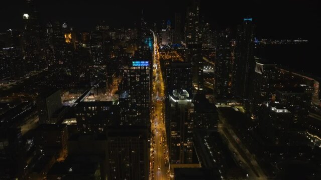 Illuminated apartment buildings in South Loop, nighttime in Chicago - Aerial view