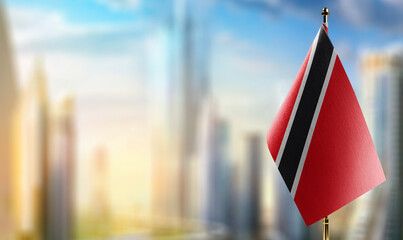 Small flags of the Trinidad and Tobago on an abstract blurry background