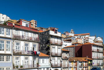 Oporto, Portugal. April 13 , 2022: Alfandega neighborhood in front of the duero houses with...