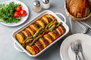 Traditional Turkish food; baked potatoes and meatballs. Turkish name; kofteli patates dizmesi, patates dizme