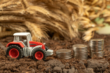 Tractor with money on the background of spikelets of wheat. Export of grain and agriculture. Rising prices for agricultural products