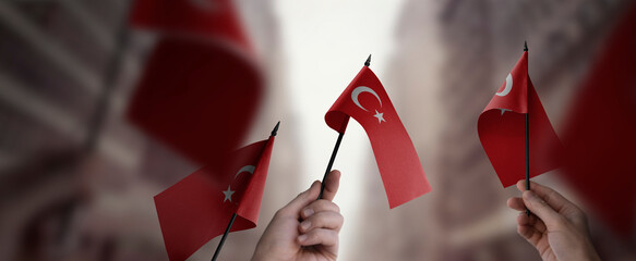 A group of people holding small flags of the Turkey in their hands