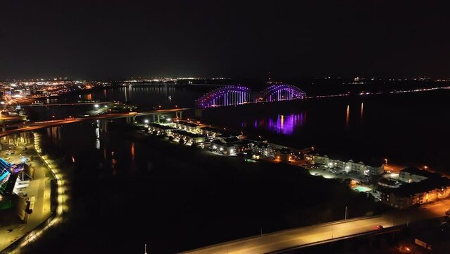 Hernado De Soto bridge in Memphis, Tennessee at night to pan of Memphis skyline with drone video.