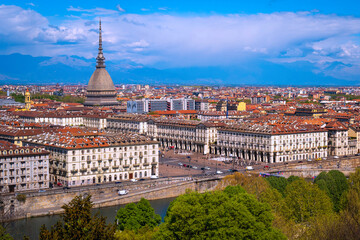 Fototapeta na wymiar Torino city skyline in vibrant spring colors, with the view of Mole Antonelliana over the Po River and Ginzburg Park, a view from Church of Santa Maria del Monte dei Cappucciniin Turin, northern Italy