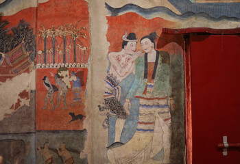 Ancient Buddhist temple mural depicting a Thai daily life scene at Wat Phumin, a famous temple in...