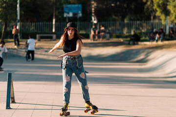 bella mujer joven andando en patines de 4 ruedas en la ciudad al atardecer en un día de verano
