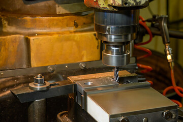 The drilling process on NC milling machine with brass material.