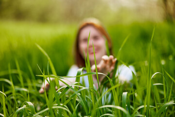 silhouette of a woman walking in tall grass. Photo out of focus