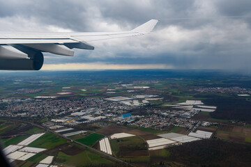 view out of an aircraft window while a passenger aircraft is landing in frankfurt, germany