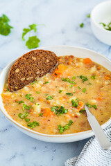 Vegan stew with potatoes, sweet potato and lentils in white bowl. Plant-based recipe.