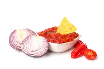 Bowl of delicious salsa sauce with nachos, onions, pepper and tomato isolated on white background