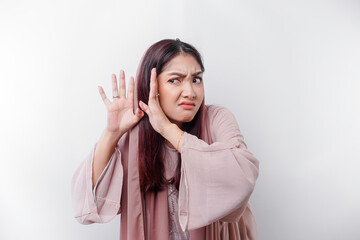 A curious young Asian Muslim woman wearing a head scarf trying to hear you overhear listening...