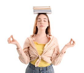 Young woman with books meditating on white background. Balance concept