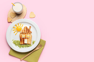 Plate with funny children's breakfast in shape of house and glass of milk on pink background