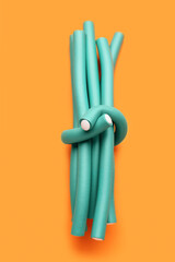 Hair curlers on orange background