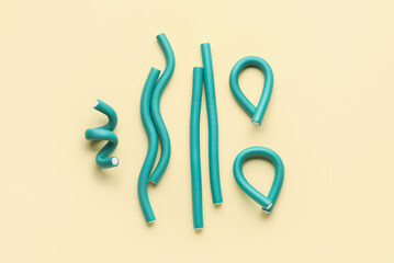 Hair curlers on yellow background
