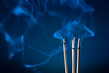 Incense sticks and incense stick smoke on black backgrond with white backlit