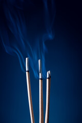 Incense sticks and incense stick smoke on black backgrond with white backlit