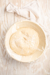 Raw yeast dough resting and rising in a special basket