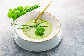 Healthy green soup with fresh spring plants, herbs, winter purslane, chives and  ramson - obrazy, fototapety, plakaty