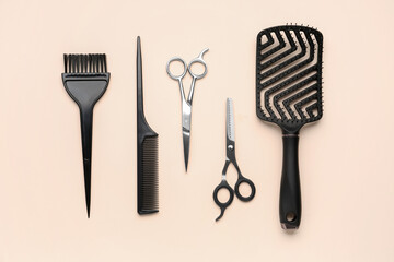 Hairdresser's brushes with scissors on beige background
