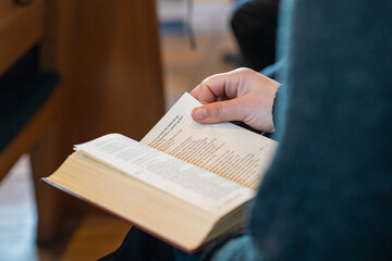 Naklejka premium Person holding hymnbook at Næsby Church in Odense Denmark from the inside