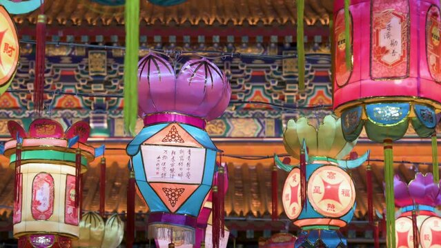 Chinese lanterns, which symbolize prosperity and good fortune, hang from ceiling wires next to a temple during the Mid-Autumn Festival, also called Mooncake Festival.