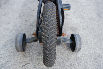 four wheel bicycle. assist wheels to help a child learn to ride a bicycle. selective focus and soft focus