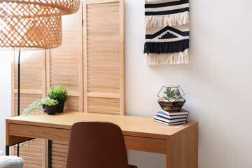 Interior of light office with modern workplace and houseplants