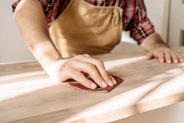 Obraz premium Carpenter works with wood in the workshop. Small business, production, craft concept.