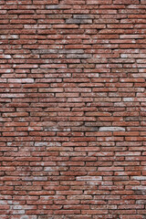Fototapeta na wymiar Vertical photo old decorative wall made of red bricks.