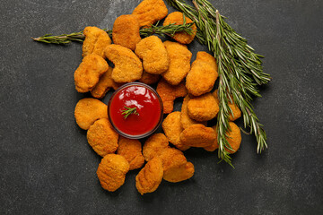 heap of tasty nuggets and ketchup on dark background