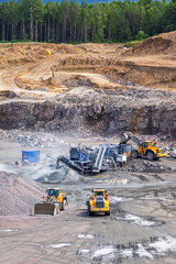 Loader tipping stones in a crushing plant in a quarry