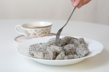 frosted pieces of dragon fruit closeup photo on white background
