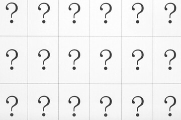 Paper with question marks, closeup