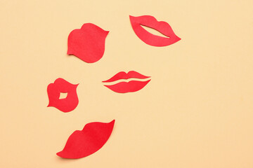 Red paper lips on beige background