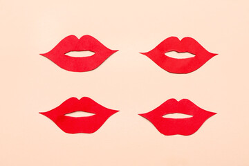 Fototapeta premium Red paper lips on beige background
